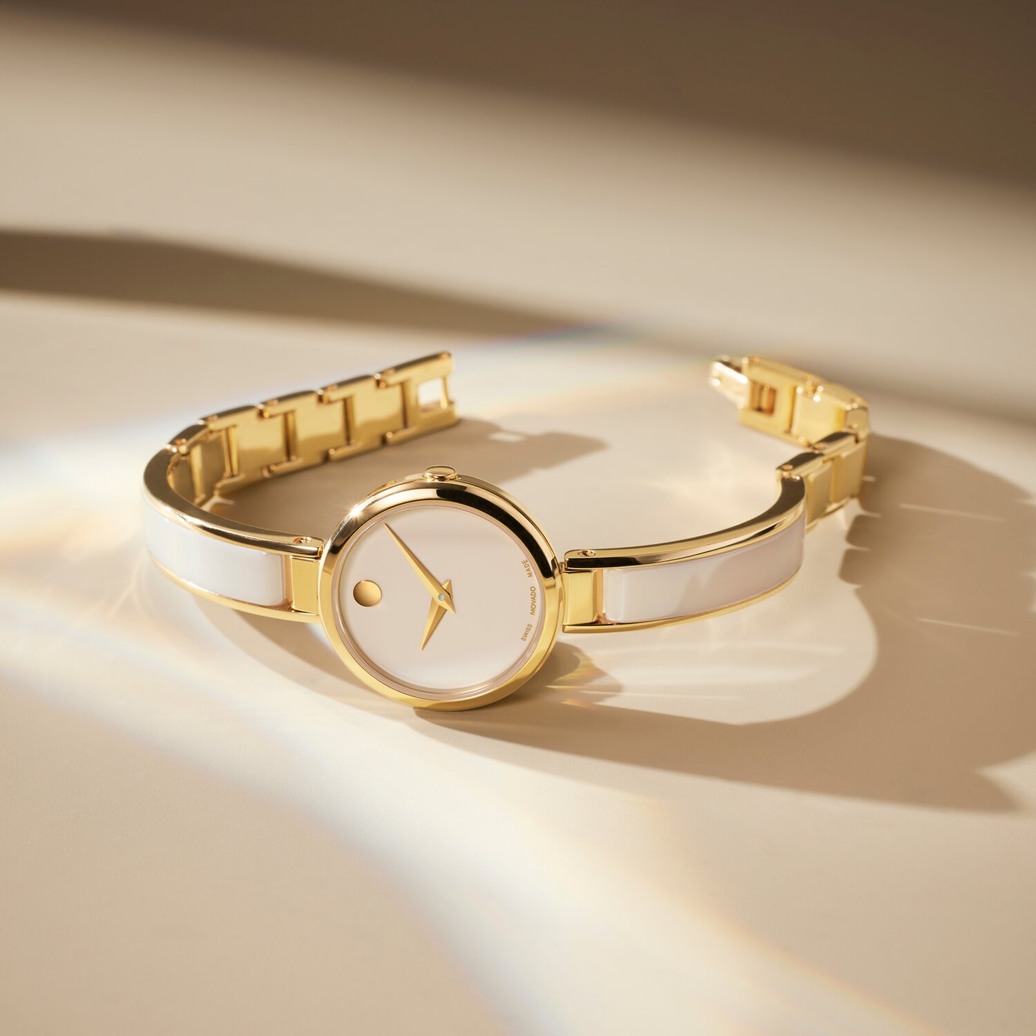 Champagne Moda Bangle watch laying on its side