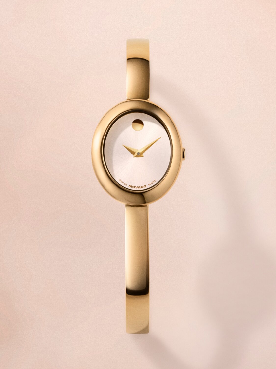 Gold tone Museum Bangle watch with white oval dial.