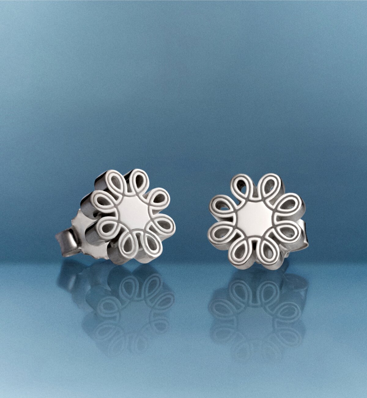 Silver women's fleur stud earrings.