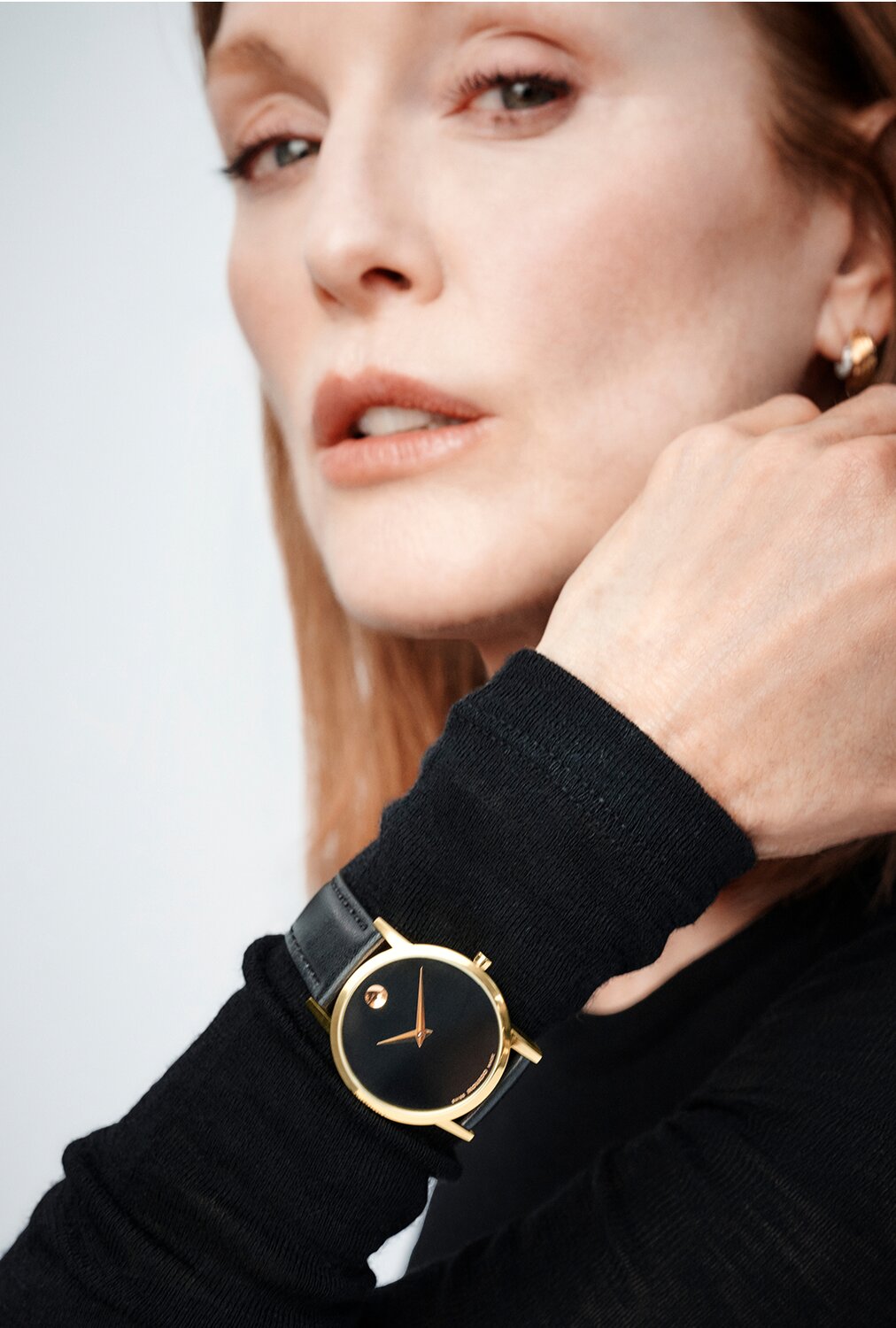 Julianne Moore wearing a black long sleeve shirt and a black Museum Classic watch with leather strap