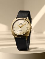 Heritage Kingmatic watch with black leather strap and gold square dial.