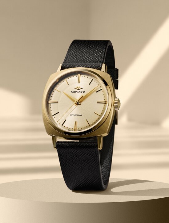 Heritage Kingmatic watch with black leather strap and gold square dial.