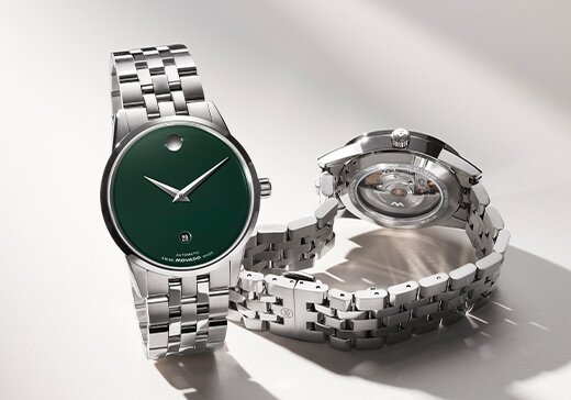 Museum Classic Automatic watch with silver bracelet and green dial next to the back of the watch with an exposed automatic movement case back