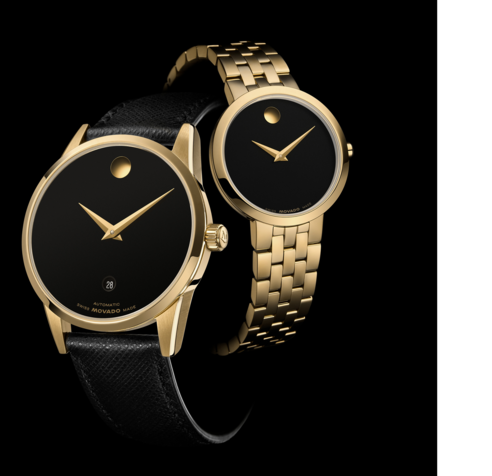 Black 40mm Museum Classic watch with leather strap and gold accents in front of a 28mm Museum Classic watch with gold tone bracelet and black dial.