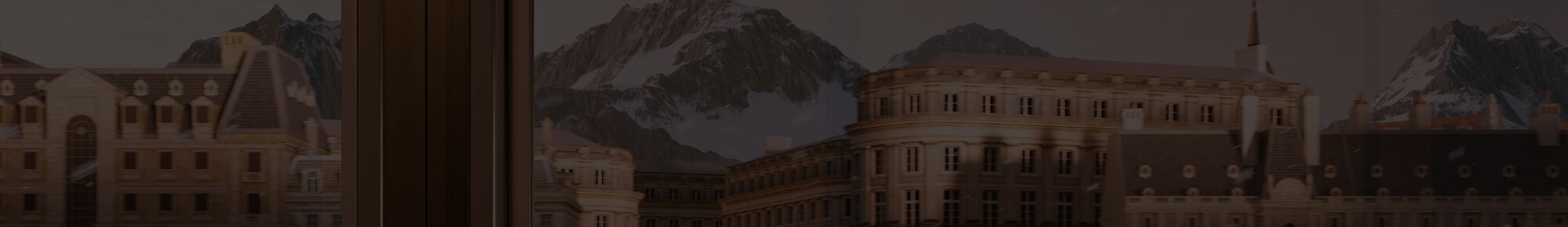 Swiss town with snow covered mountains in the background