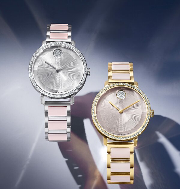 Silver BOLD Evolution 2.0 bracelet watch with pink ceramic in lays and crystal bezel next to a gold tone BOLD Evolution 2.0 bracelet watch with taupe ceramic in lays and crystal bezel.