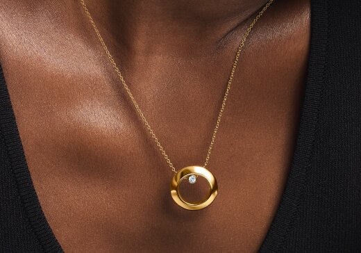 Woman wearing the gold tone Ono Necklace