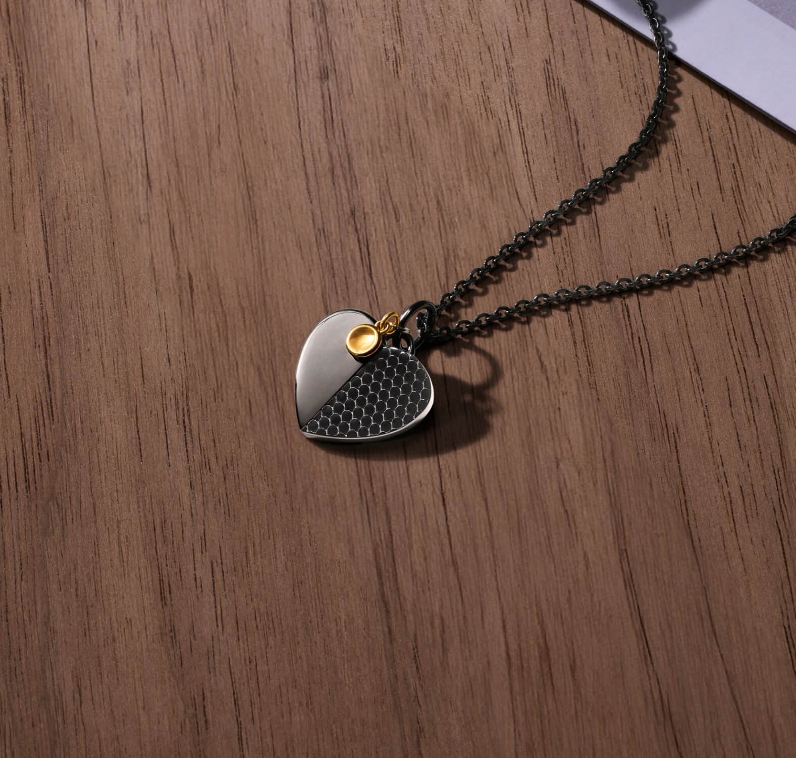 Movado Heart Necklace laying on wooden table