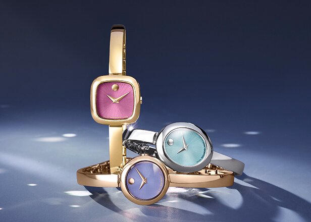 Museum Bangle watches in gold tone with pink dial, rose gold tone with purple dial and silver with blue dial.
