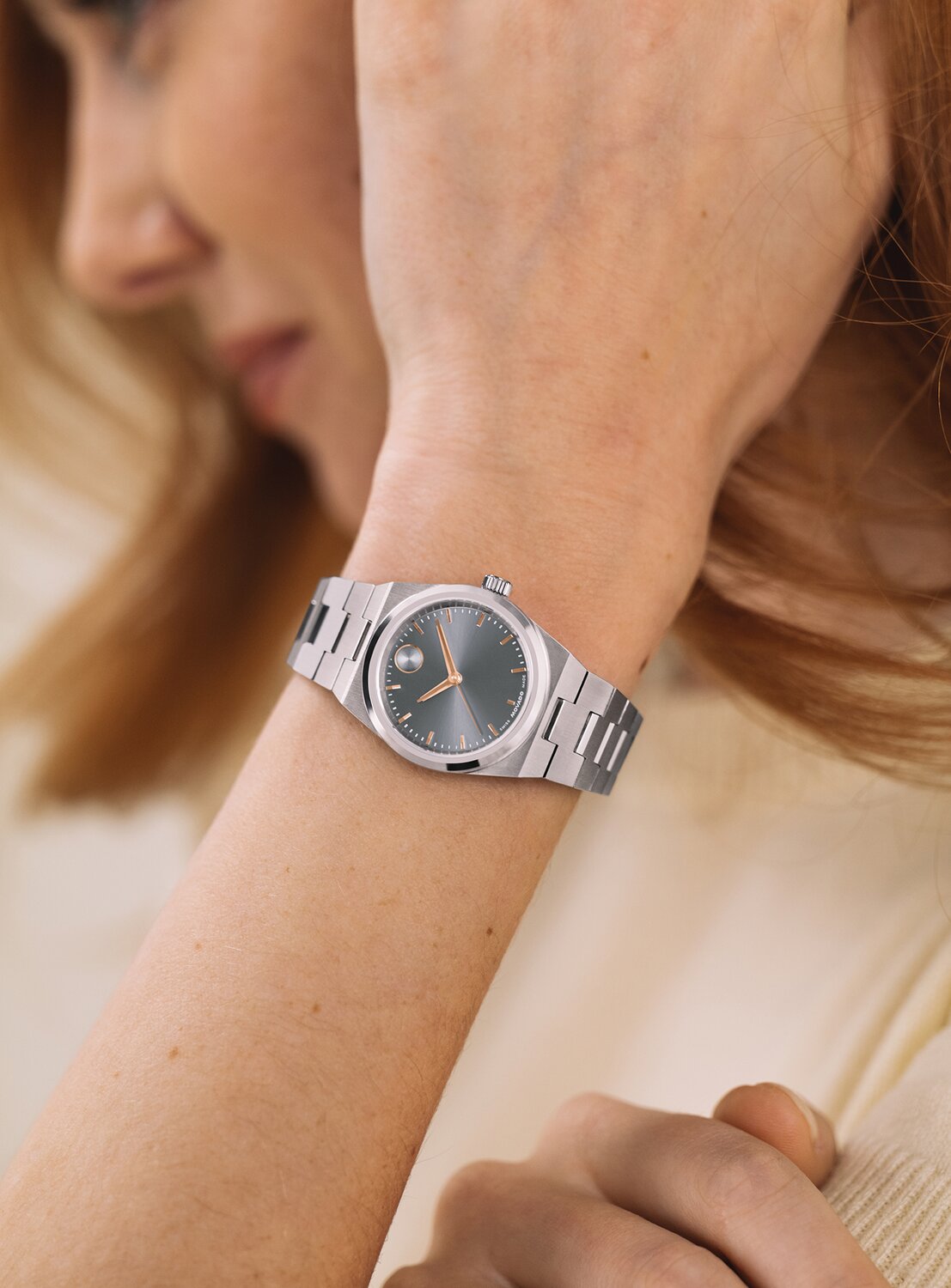 Woman in a white shirt wearing a silver BOLD Quest Mini watch.