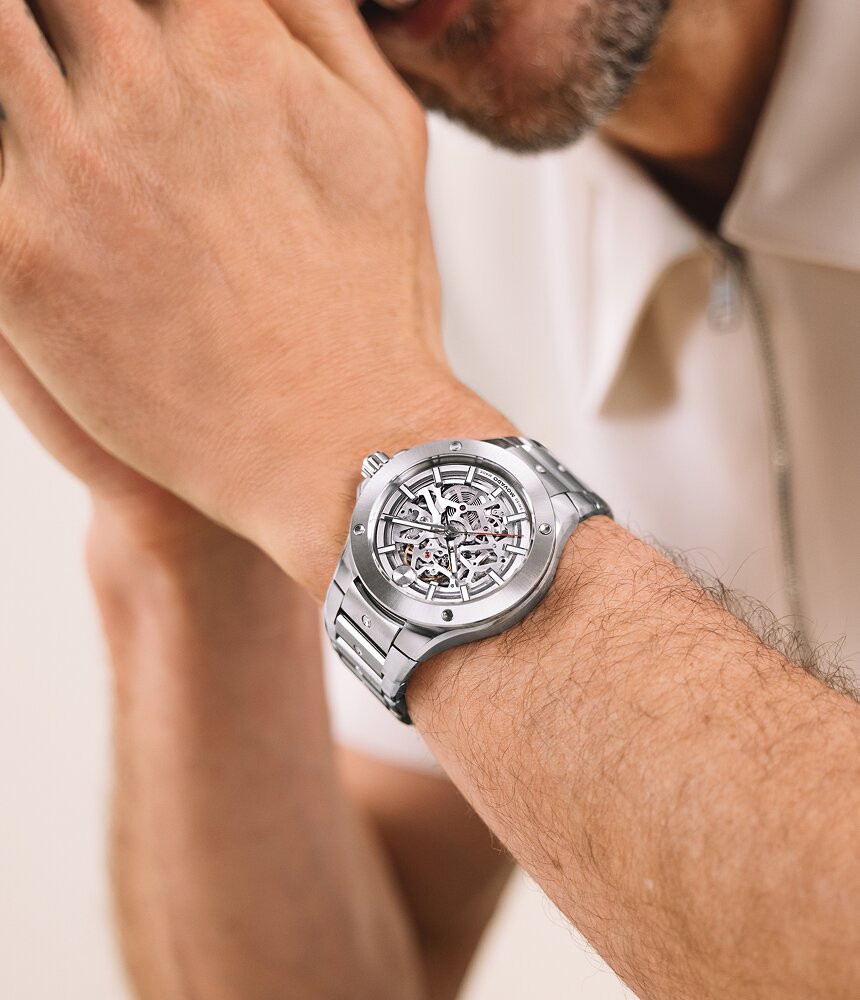 Man wearing the Movado Alta SE Automatic watch in stainless steel with skeleton dial.