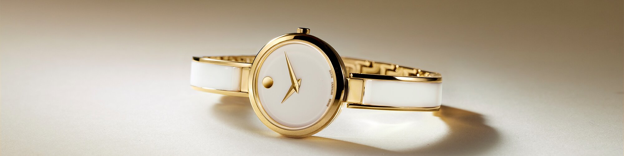 White Moda bangle watch with gold tone accents