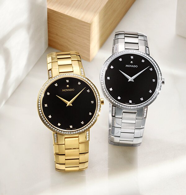 Gold tone Faceto bracelet watch with black dial and diamonds next to a silver Faceto bracelet watch with black dial and diamonds