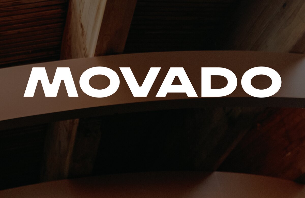 Wooden ceiling panels dimmed behind the movado logo in white