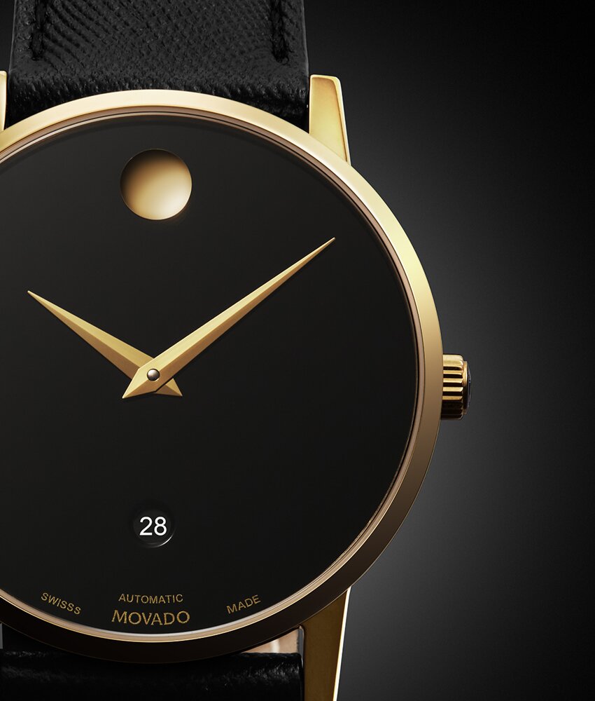 Close up of the Dial of the Museum Classic automatic watch with black strap and black dial with gold accents.