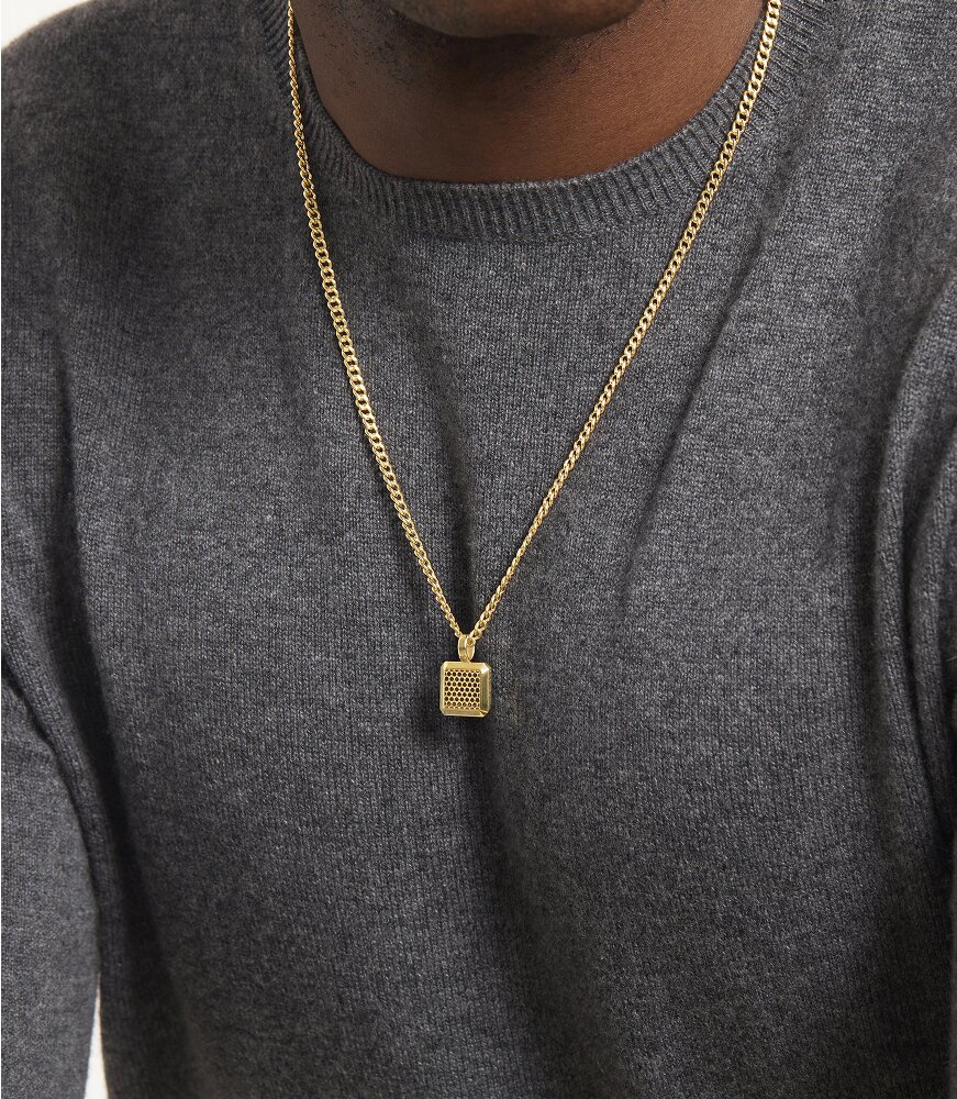 Man in a grey sweater wearing the gold plated square necklace.