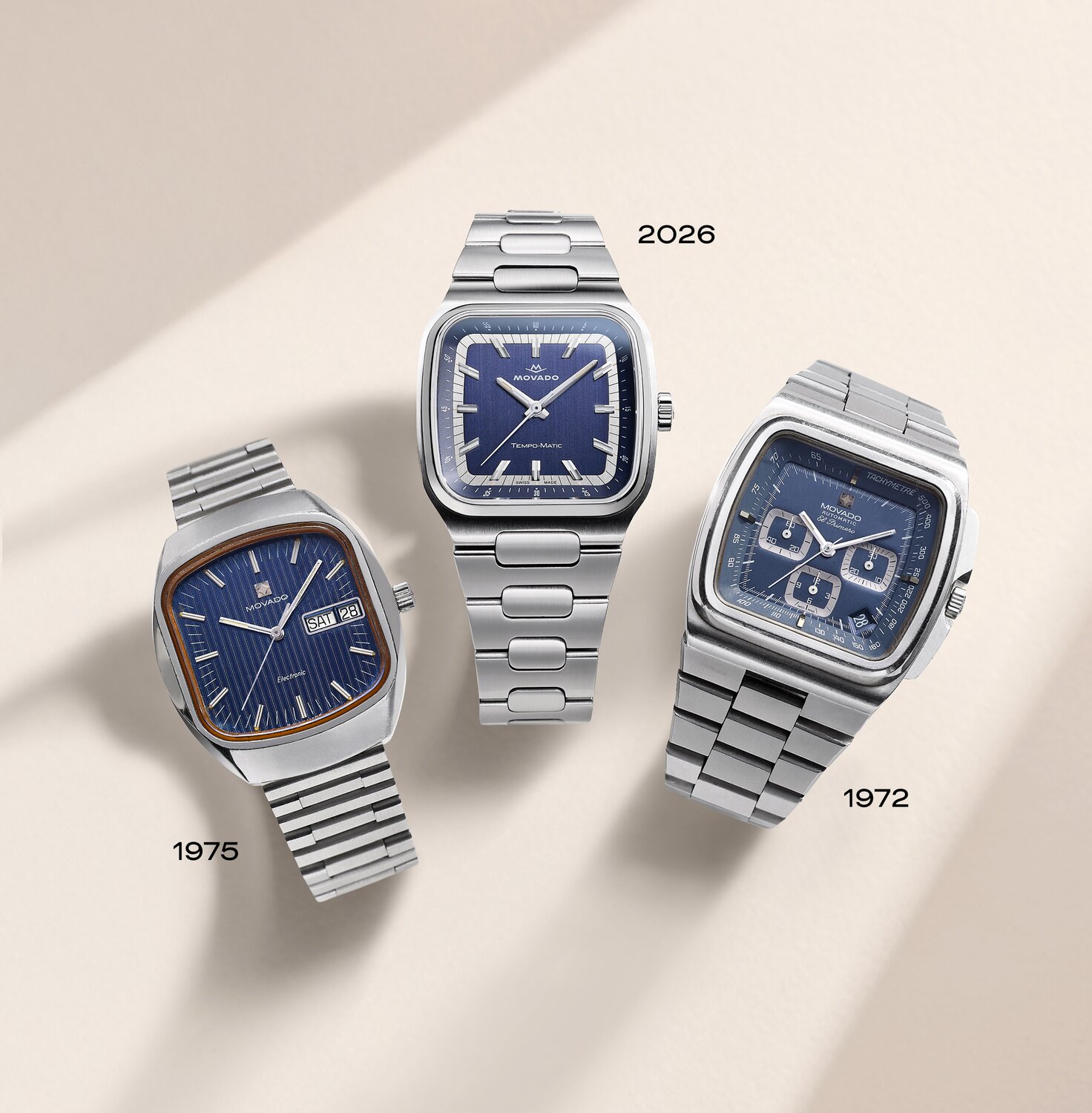 Three TV-Shaped case watches with stainless steel bracelets and blue dials. First watch has date, "1975", second watch has date, "2026", third watch has date, "1972".