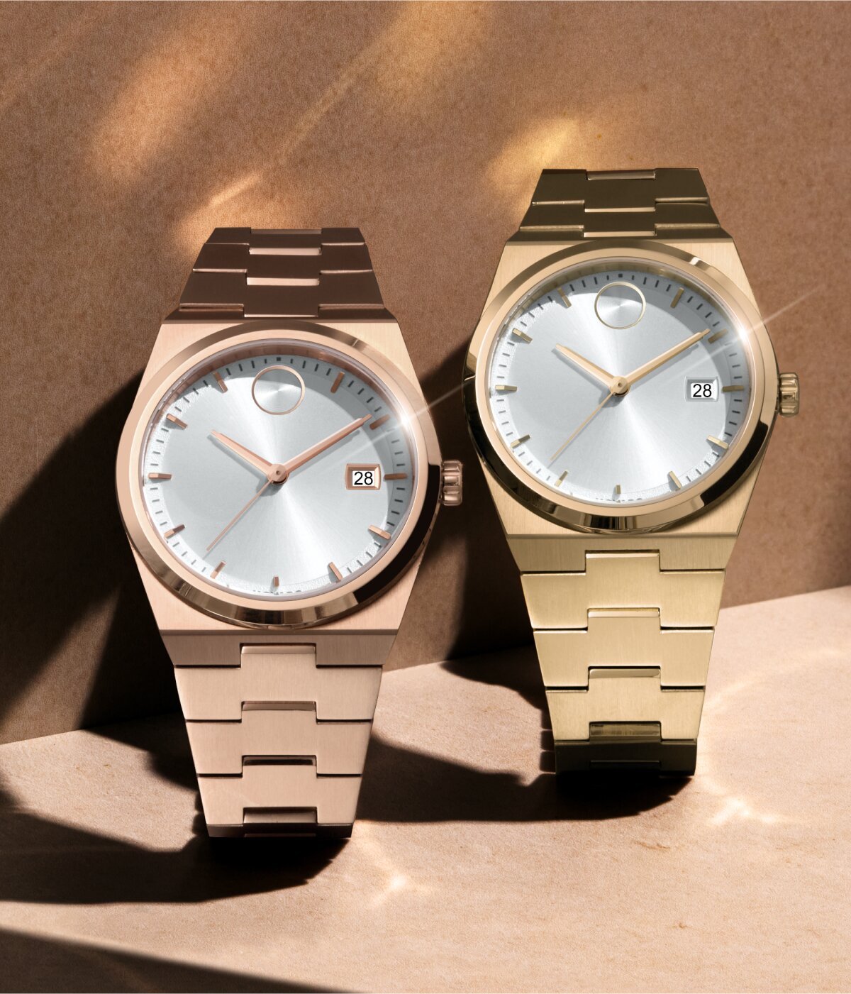 Rose gold tone BOLD Quest watch with white dial next to a gold tone BOLD Quest watch with white dial
