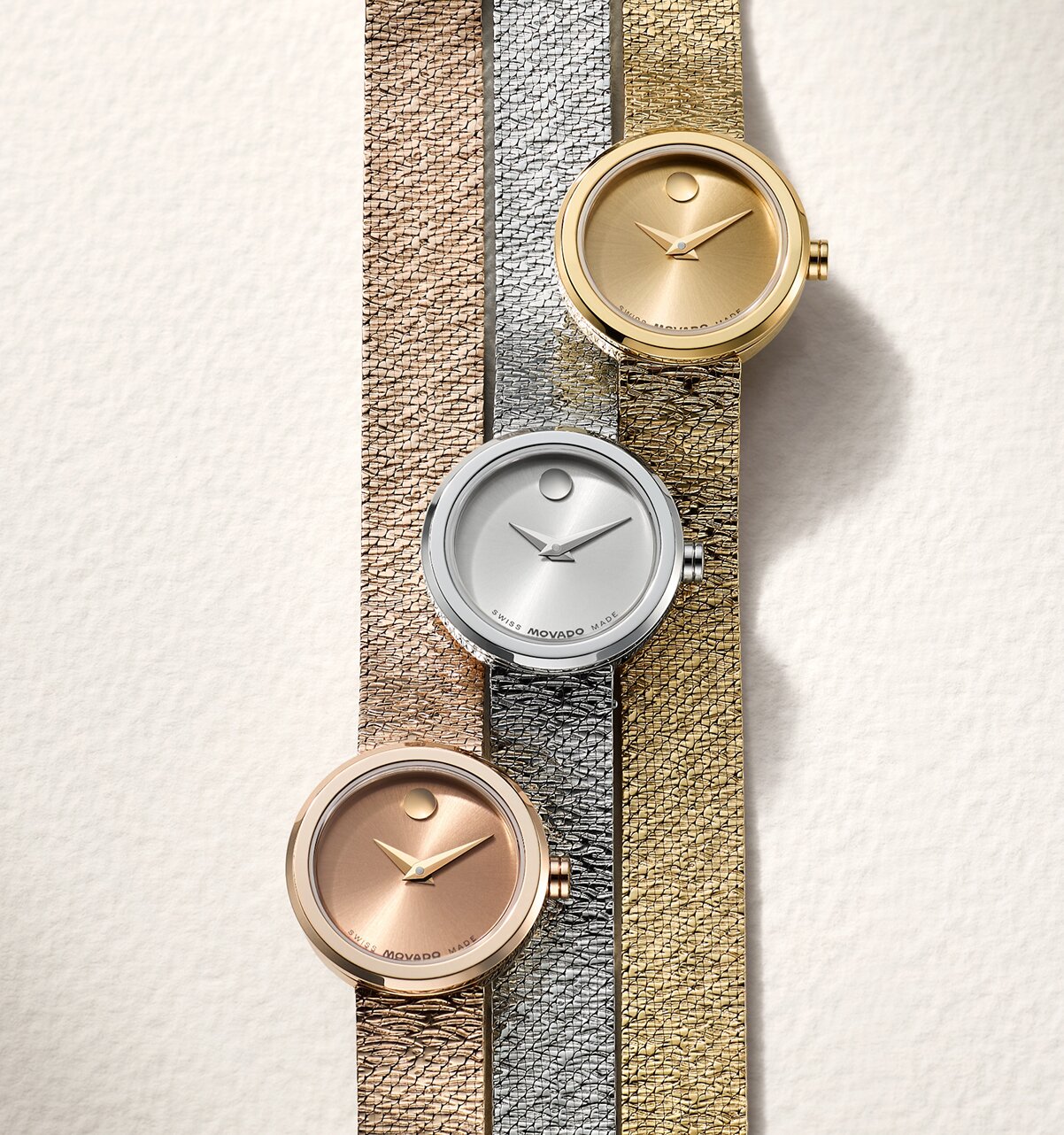 Rose gold tone BOLD Quest watch with white dial next to a gold tone BOLD Quest watch with white dial