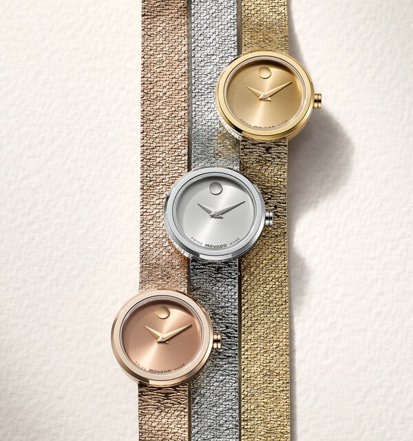 Rose gold tone BOLD Quest watch with white dial next to a gold tone BOLD Quest watch with white dial