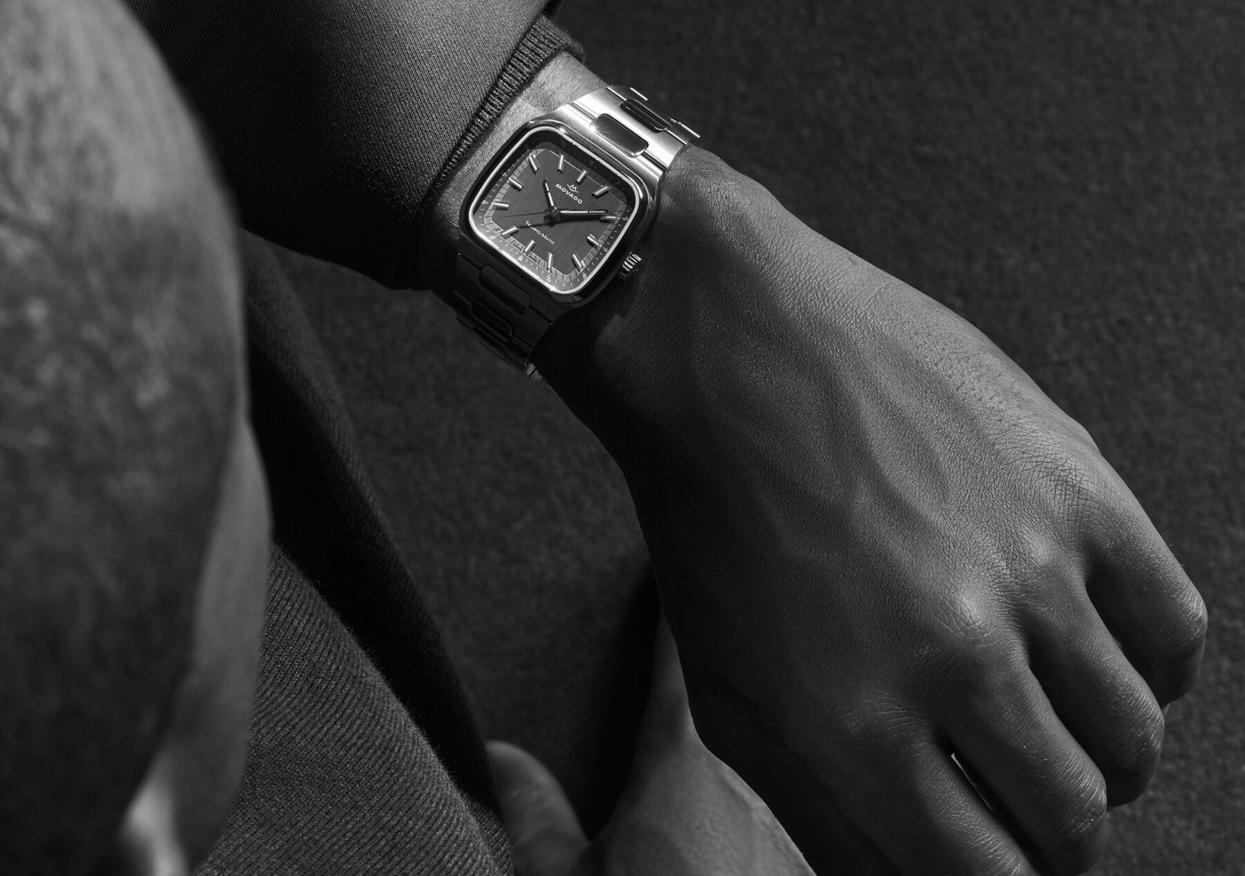 Black and white image of someone wearing the Tempo-Matic bracelet watch with TV-Shaped case.