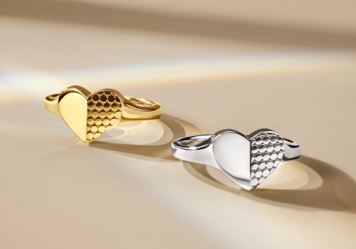 Gold tone heart ring next to silver heart ring