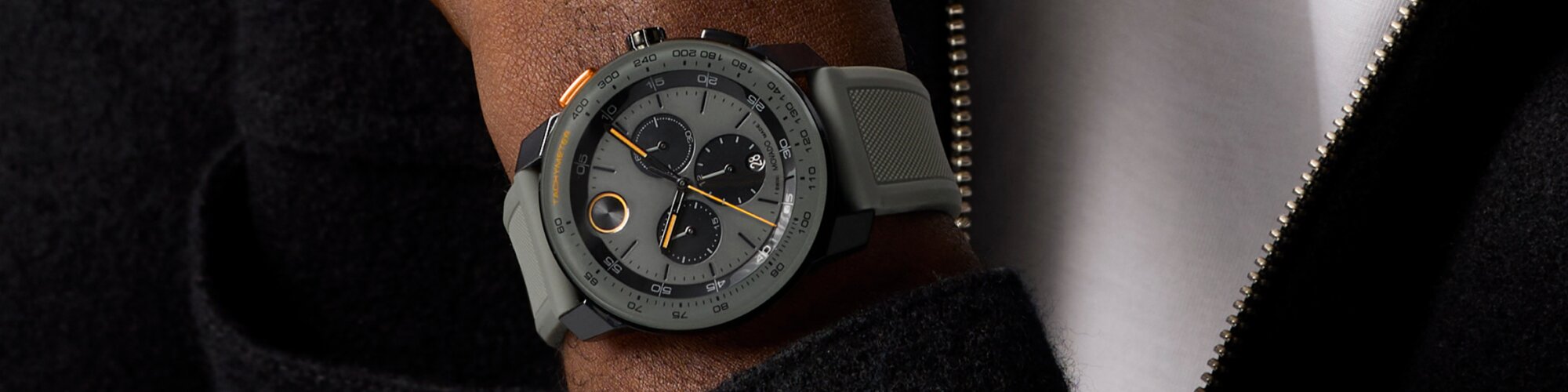 Man wearing the BOLD TR90 Chronograph watch with grey silicon strap and grey dial with black sub dials.