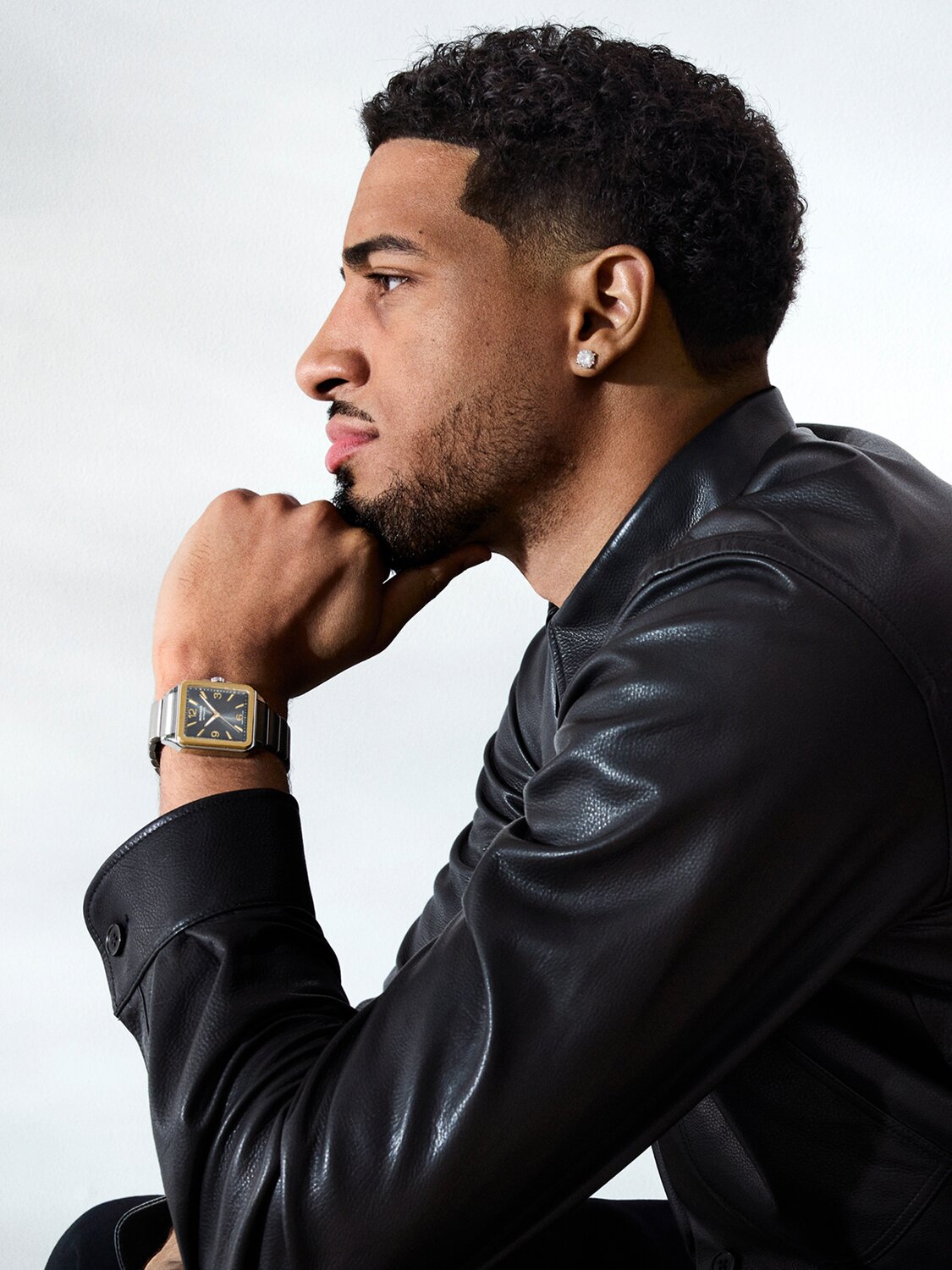 Tyrese Haliburton leaning on his hand wearing the stainless steel 1917 bracelet watch with square dial.