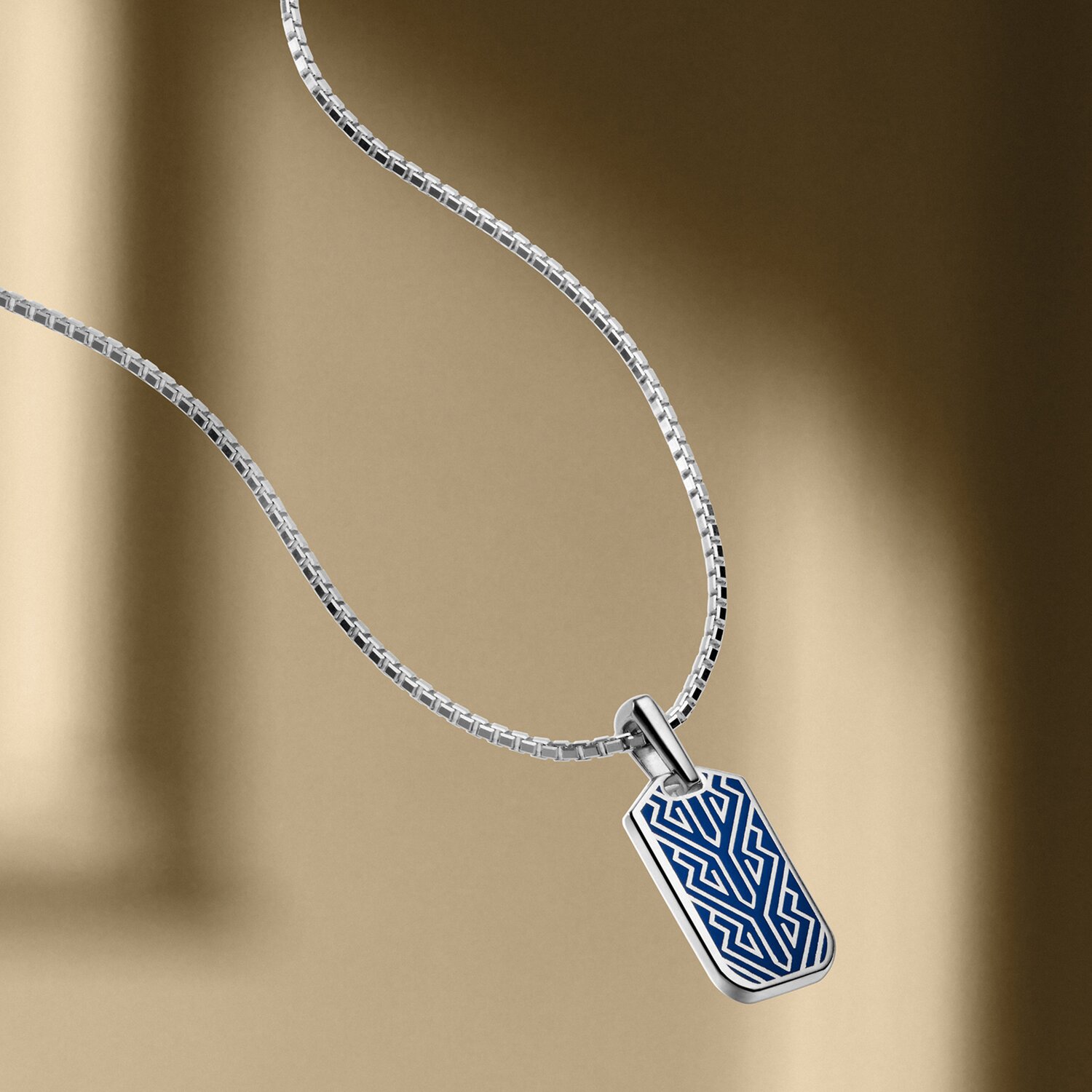Men's M Chevron Necklace with silver chain and blue pendant.