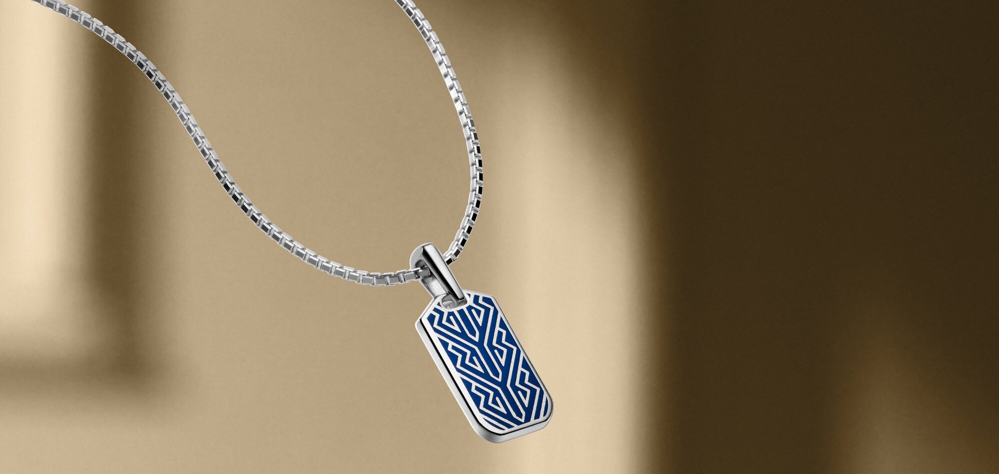Men's silver chain necklace with blue chevron pendant.