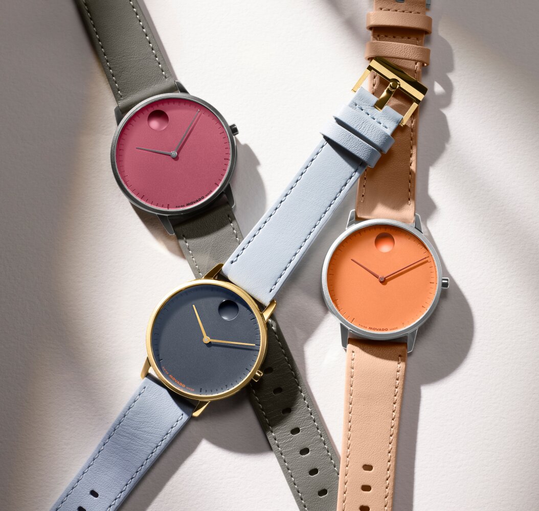 Movado Face watches in grey and pink, blue and orange.