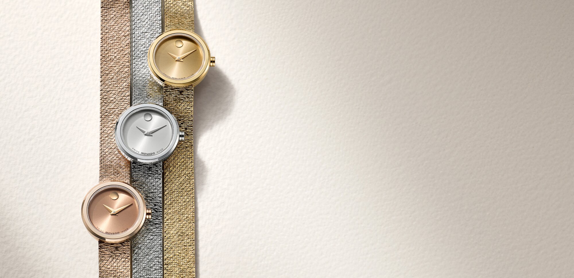 Rose gold tone BOLD Quest watch with white dial next to a gold tone BOLD Quest watch with white dial