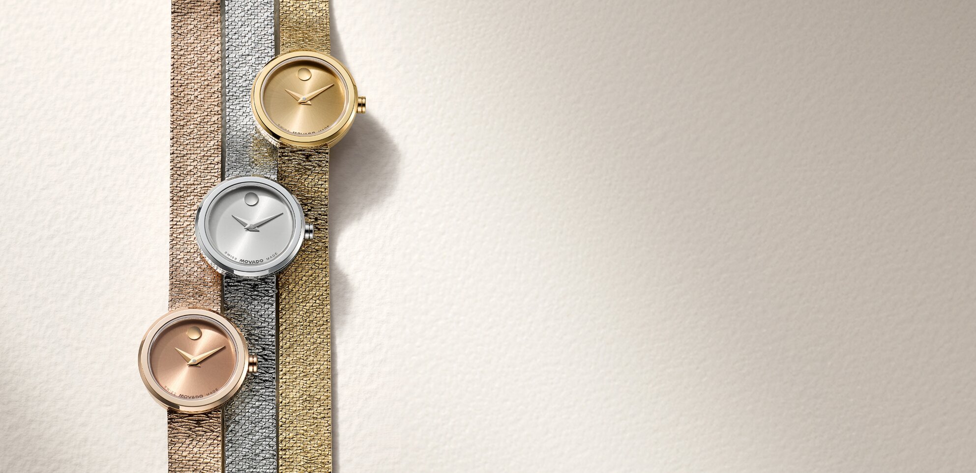 Rose gold tone BOLD Quest watch with white dial next to a gold tone BOLD Quest watch with white dial