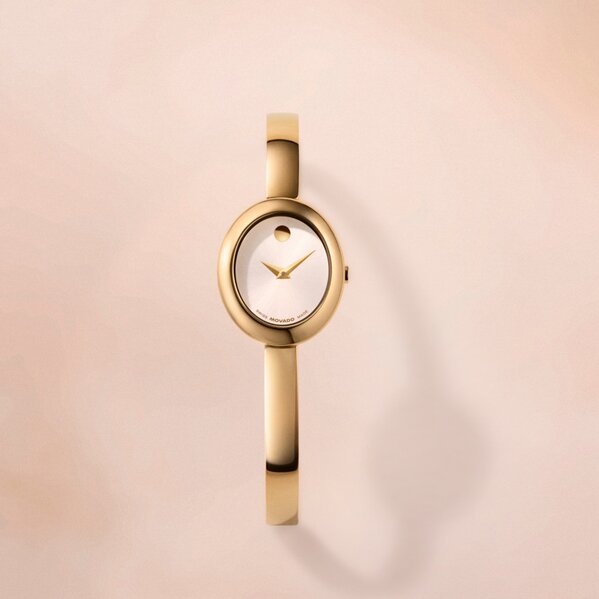 Gold tone Museum Bangle watch with white oval dial.