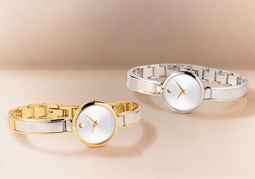 Two tone Moda bangle watches laying next to each other