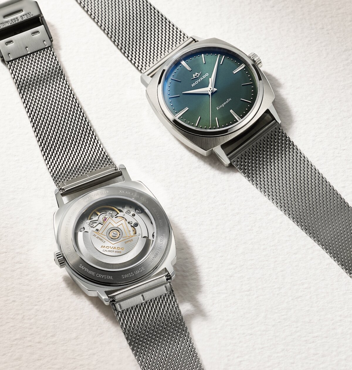 Front and back of the Heritage Kingamtic watch with stainless steel mesh bracelet and blue dial with exposed case back.