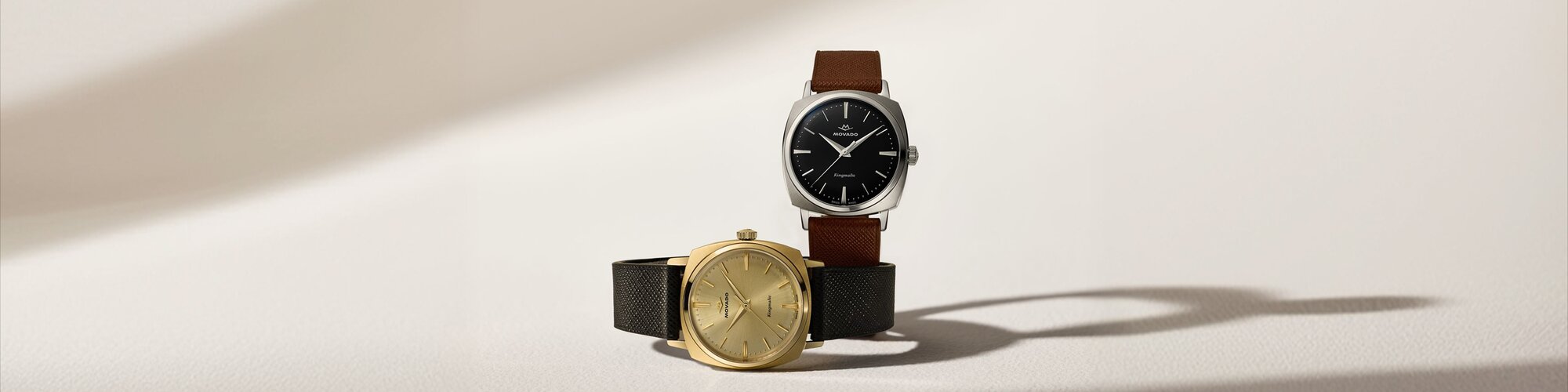 Heritage Kingmatic watch with brown strap and black square dial and black strap and gold square dial.