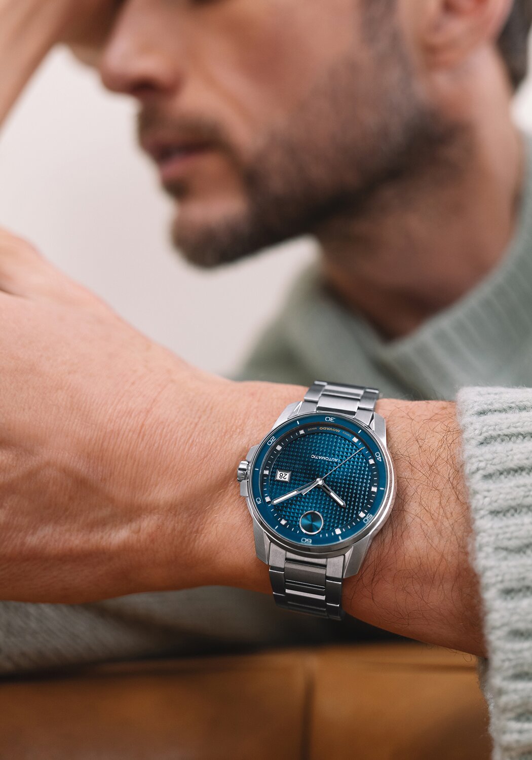 Man wearing a BOLD Verso Automatic  stainless steel bracelet watch with blue dial.