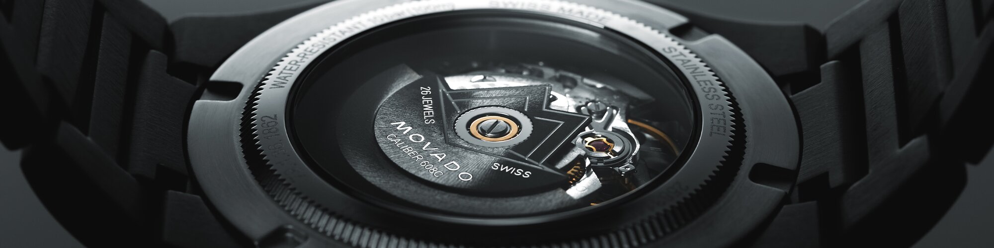 Back of a black PVD watch with exposed caseback that shows the automatic movement
