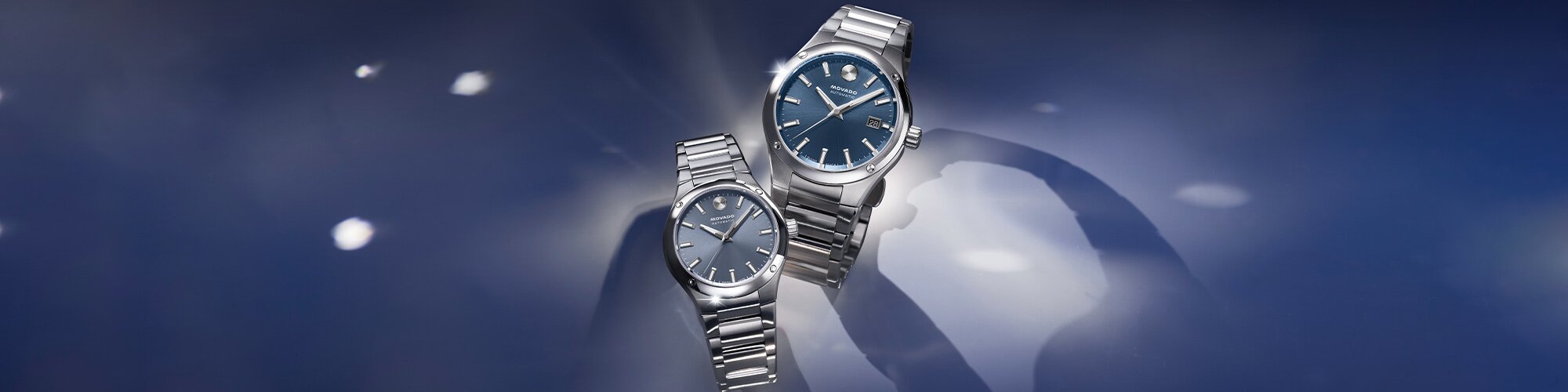 Men's and Women's Museum Imperiale watches with stainless steel bracelets and blue dials.
