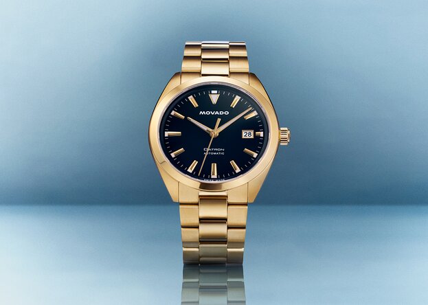 Heritage Datron watch with gold tone bracelet and blue dial.