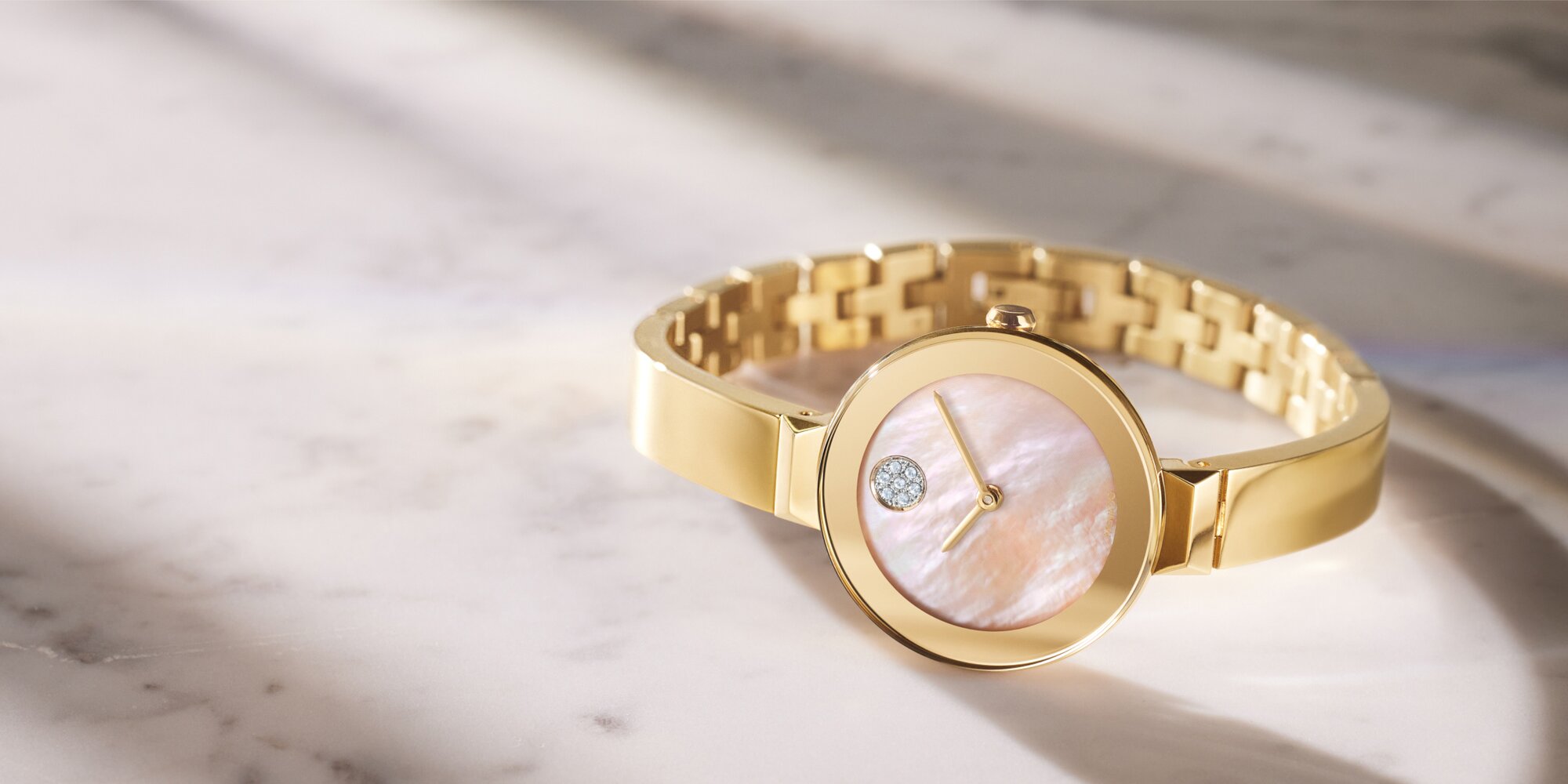 Gold tone BOLD Bangle watch with mother of pearl diamond and crystal dot