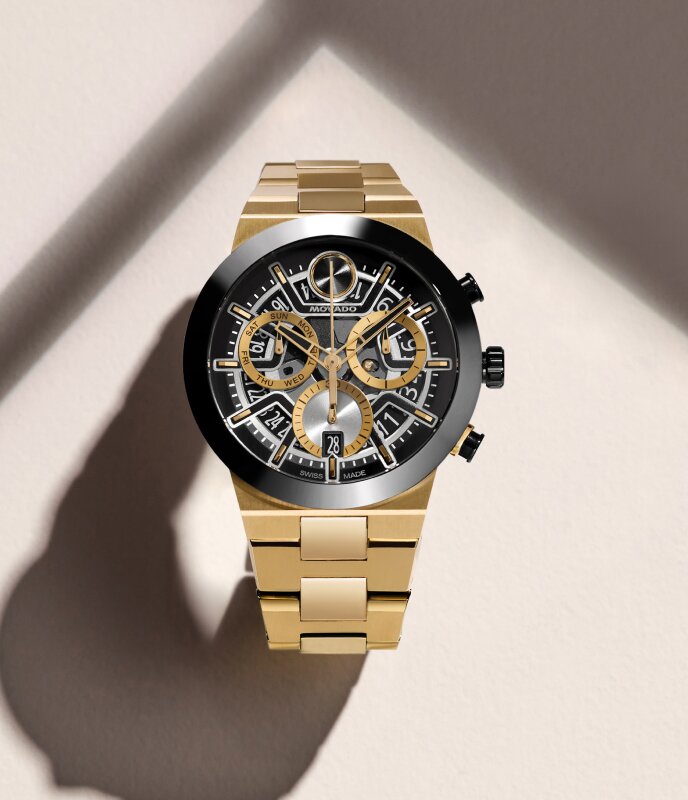 Gold tone BOLD Fusion bracelet watch with black, gold and silver chronograph skeleton dial.