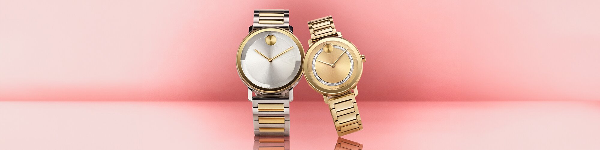 Two Tone BOLD Evolution 2.0 men's bracelet watch next to a women's gold tone BOLD Evolution 2.0 bracelet watch with crystals