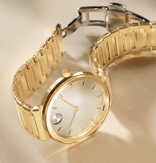 Gold tone BOLD Horizon bracelet watch laying on its side