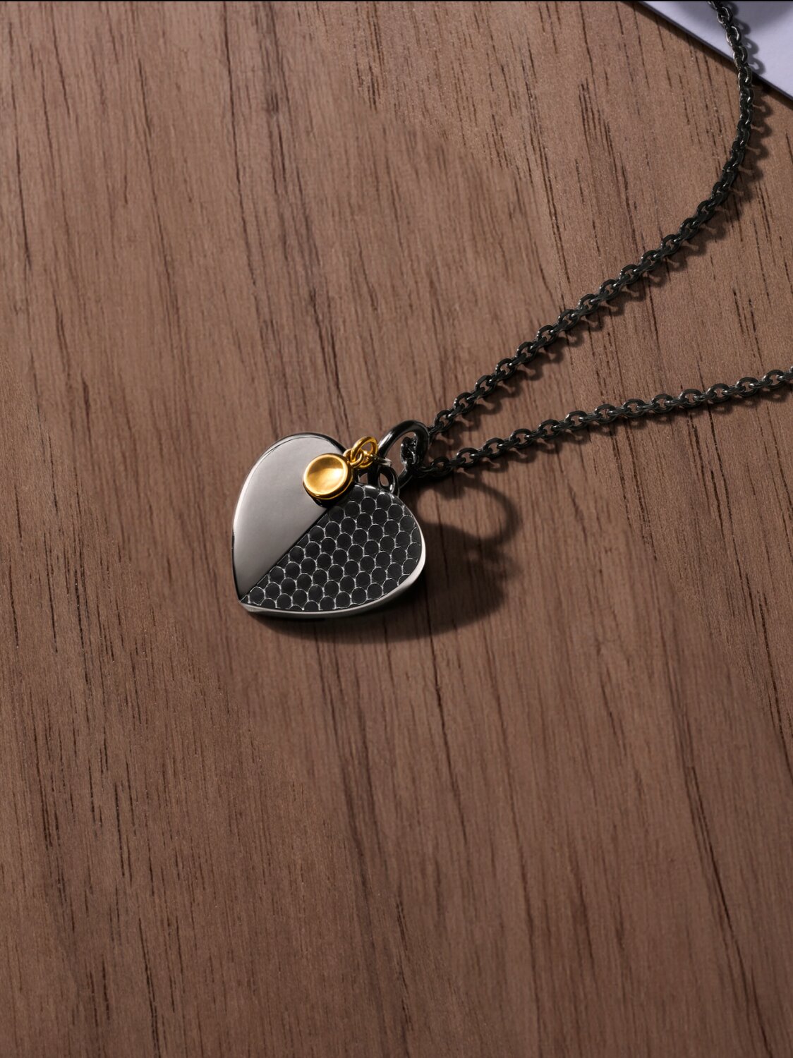 Movado Heart Necklace laying on wooden table