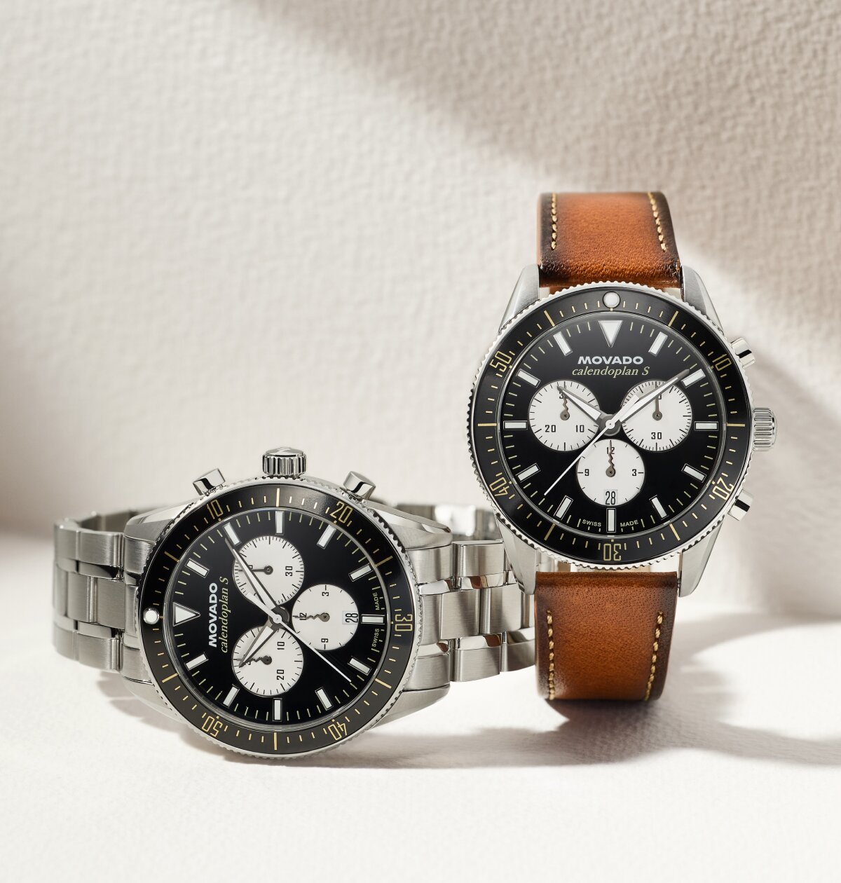 Two Heritage Series Calendoplan S watches one with stainless steel bracelet and black and white chronograph dial and the other with brown leather strap with black and white chronograph dial.