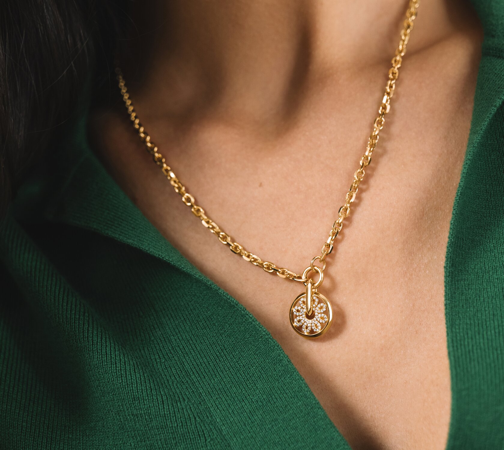 Woman in a green shirt wearing the gold tone Fleur necklace featuring lab grown diamonds