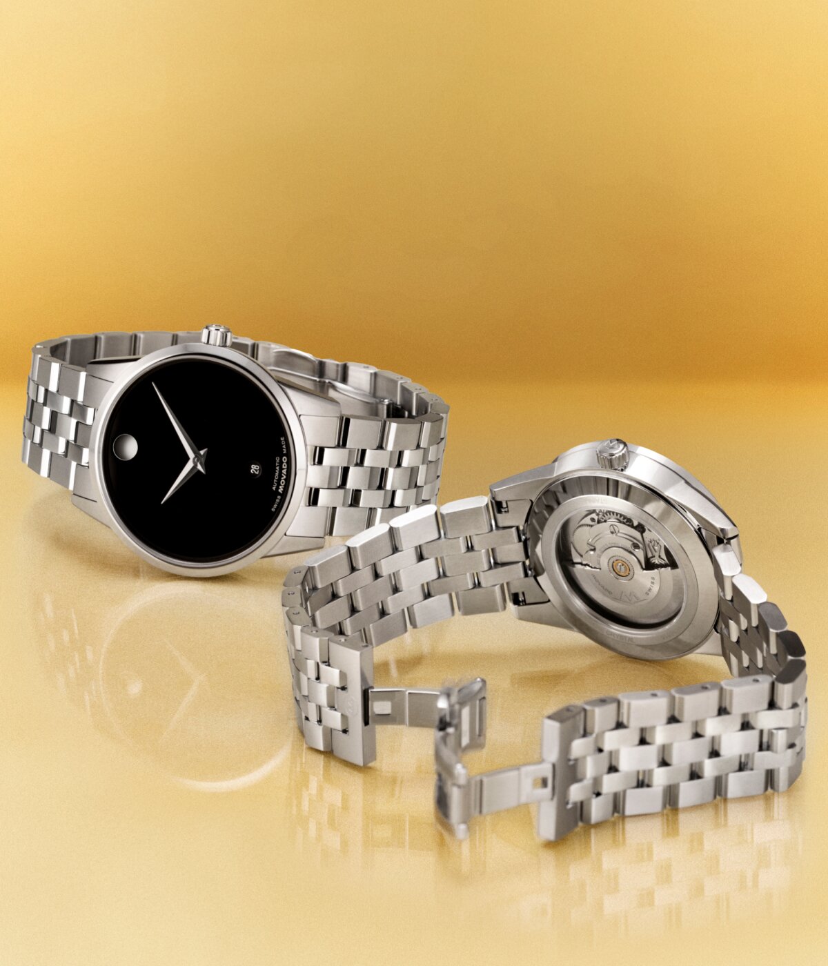 Museum Classic watch with silver bracelet watch and black dial next to the back of the watch with an exposed caseback