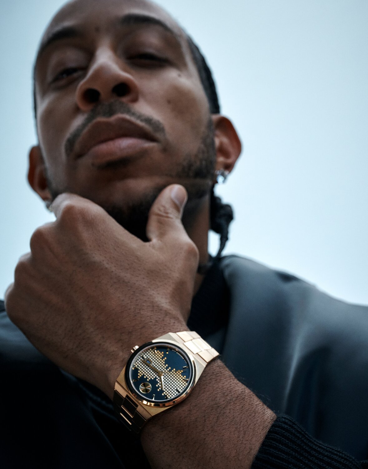 Christian McCaffrey sitting down in a suit wearing a Museum Imperiale watch with blue dial and silver bracelet.